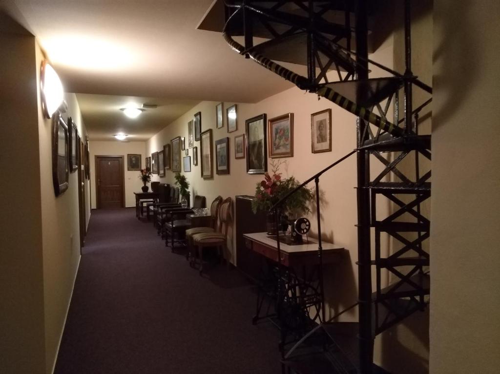 a hallway with chairs and a staircase in a building at Guest House U Zámku in Slatiňany