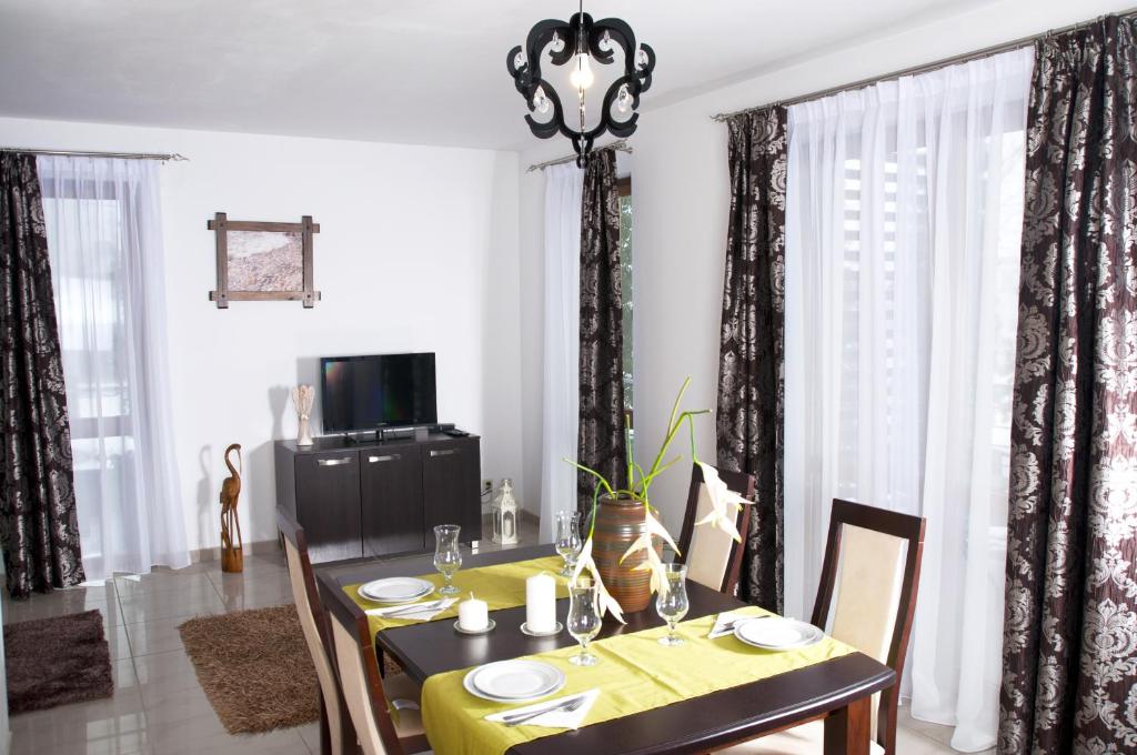 a dining room with a table with a yellow table cloth at Apartament IKAR blisko morza in Rewal