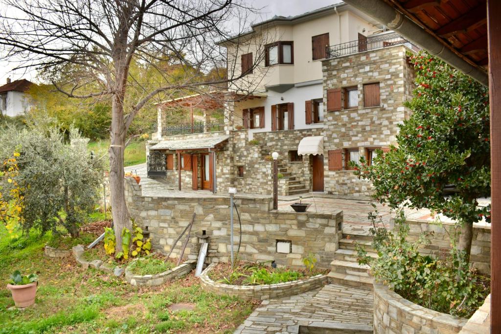 a stone house with stairs in front of it at Villa Stefanos in Katochori