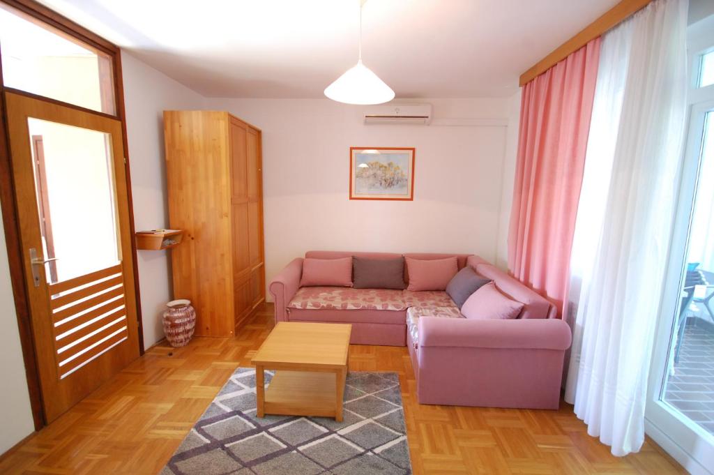 a living room with a couch and a table at Mezlar Apartment in Njivice