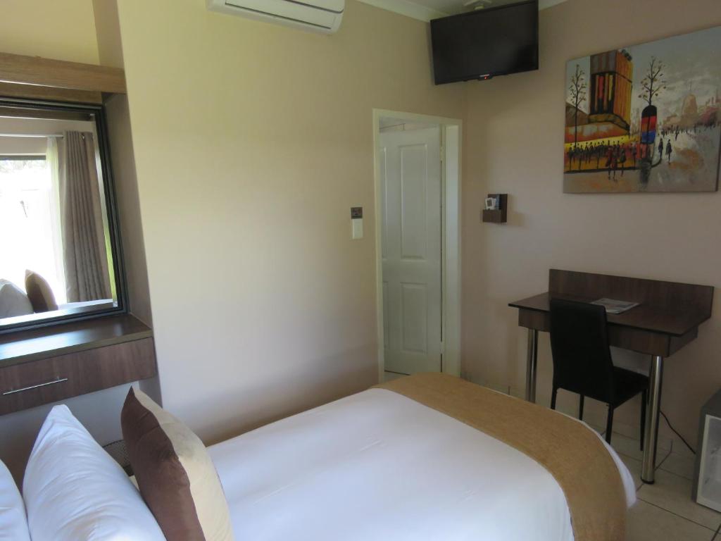 Postel nebo postele na pokoji v ubytování Andante Guesthouse Klerksdorp