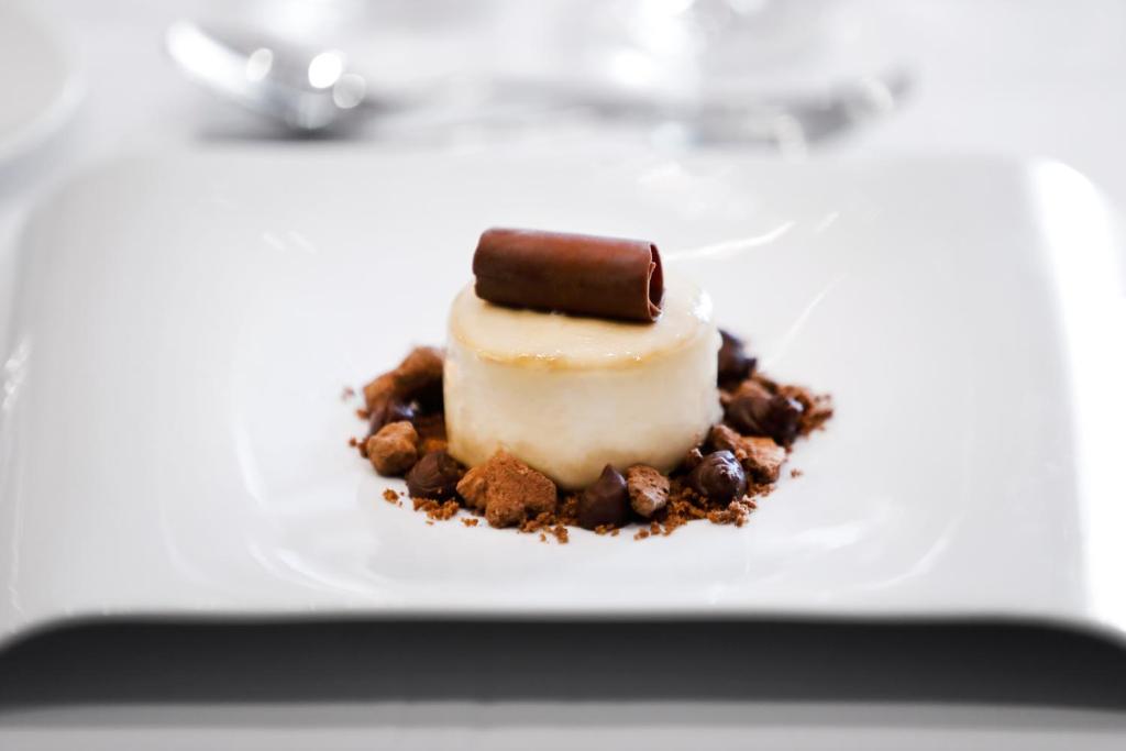 a dessert on a white plate on a table at Hotel Alimara in Barcelona