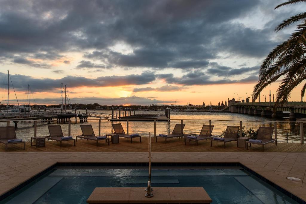 a view of a pool with chairs and a marina at Marker 8 Hotel and Marina in St. Augustine