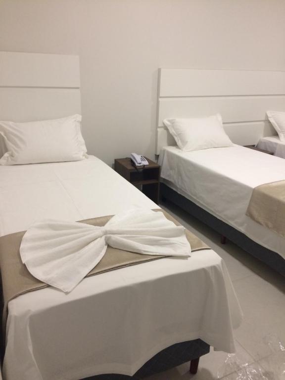Postel nebo postele na pokoji v ubytování Hotel Portal Guanambi