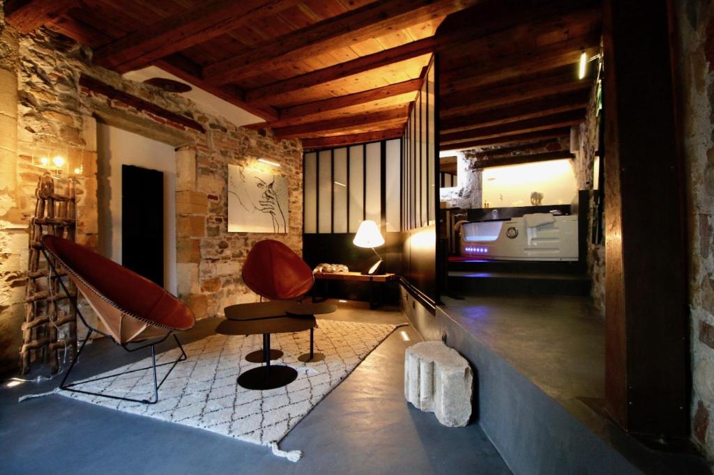 a living room with two chairs and a table at Le Clos de Sainte Croix in Lyon
