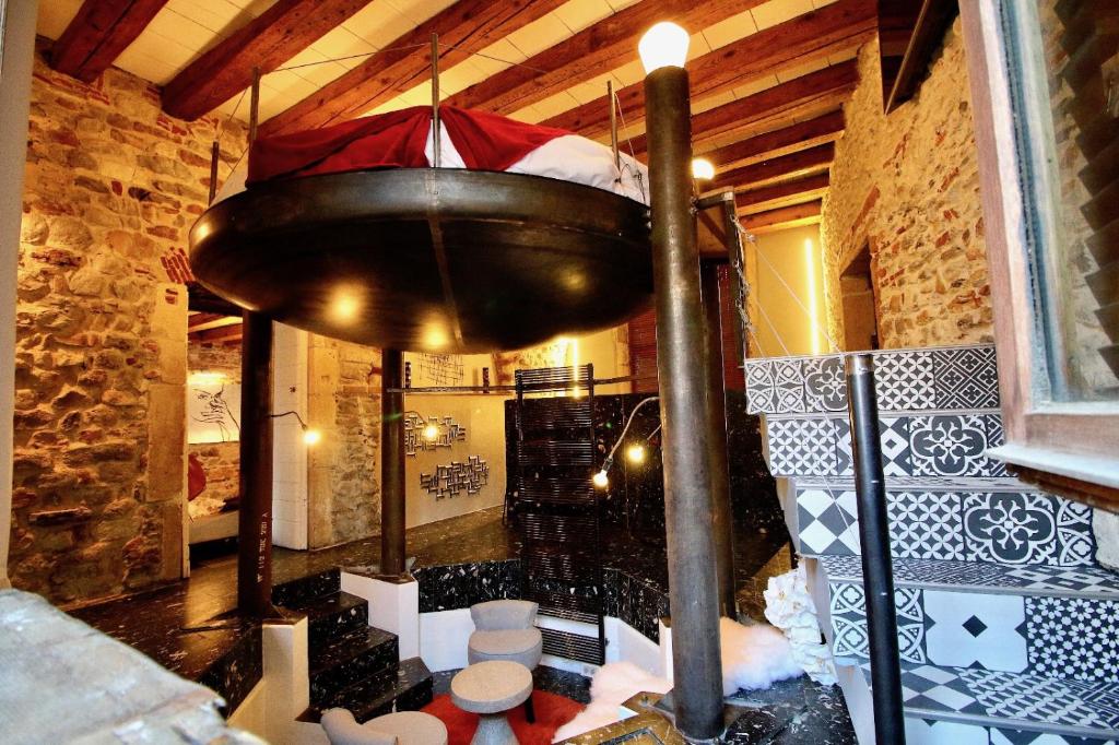 a room with a large light hanging from the ceiling at Le Clos de Sainte Croix in Lyon