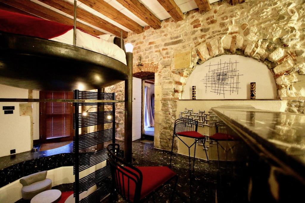 a room with a bar with red chairs in a building at Le Clos de Sainte Croix in Lyon