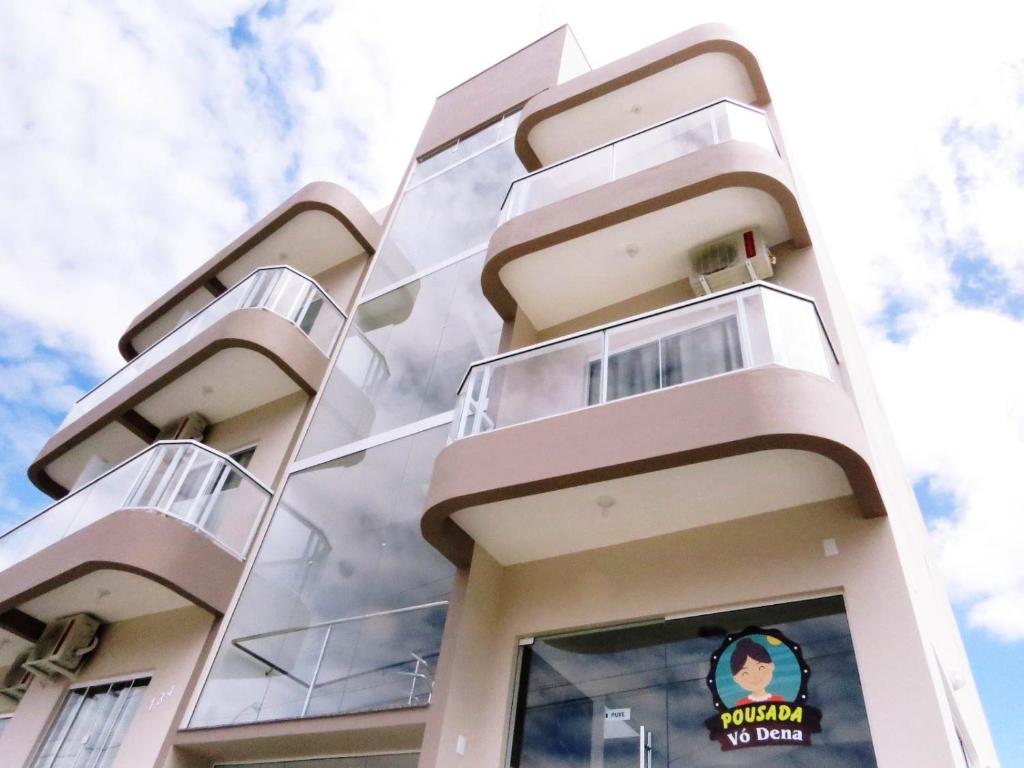 a facade of a building with glass windows at Pousada Vó Dena in Penha
