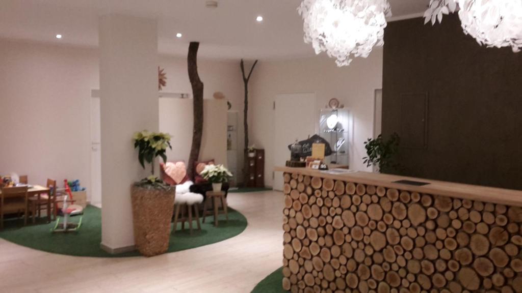 a lobby with a table and chairs and a counter at Hotel-Restaurant Sonnenhof in Veitsrodt