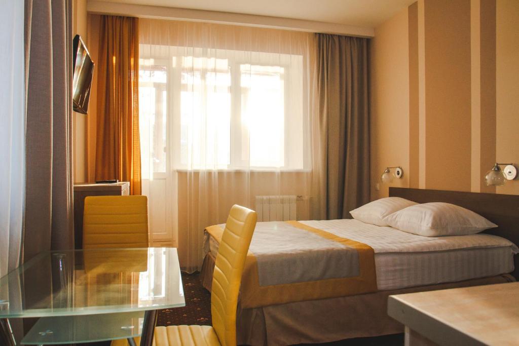 
Кровать или кровати в номере Tyumen Time Hotel
