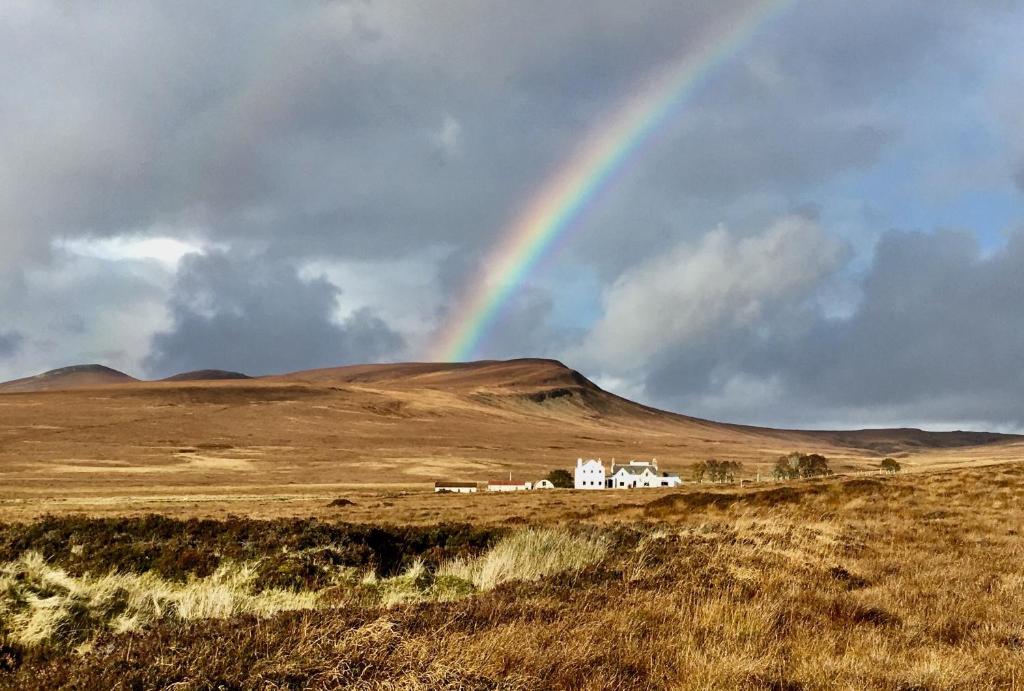 a rainbow in the sky over a field with a house at Garvault House in Kinbrace