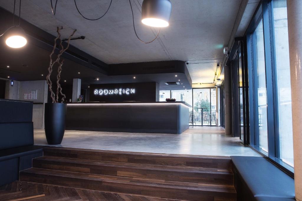 a lobby of a building with stairs and windows at Roomreich in Ingolstadt