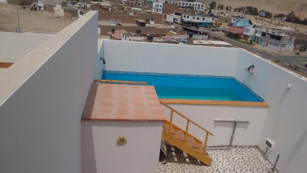 a view of a swimming pool on the roof of a building at Departamentos Playa San Bartolo in San Bartolo