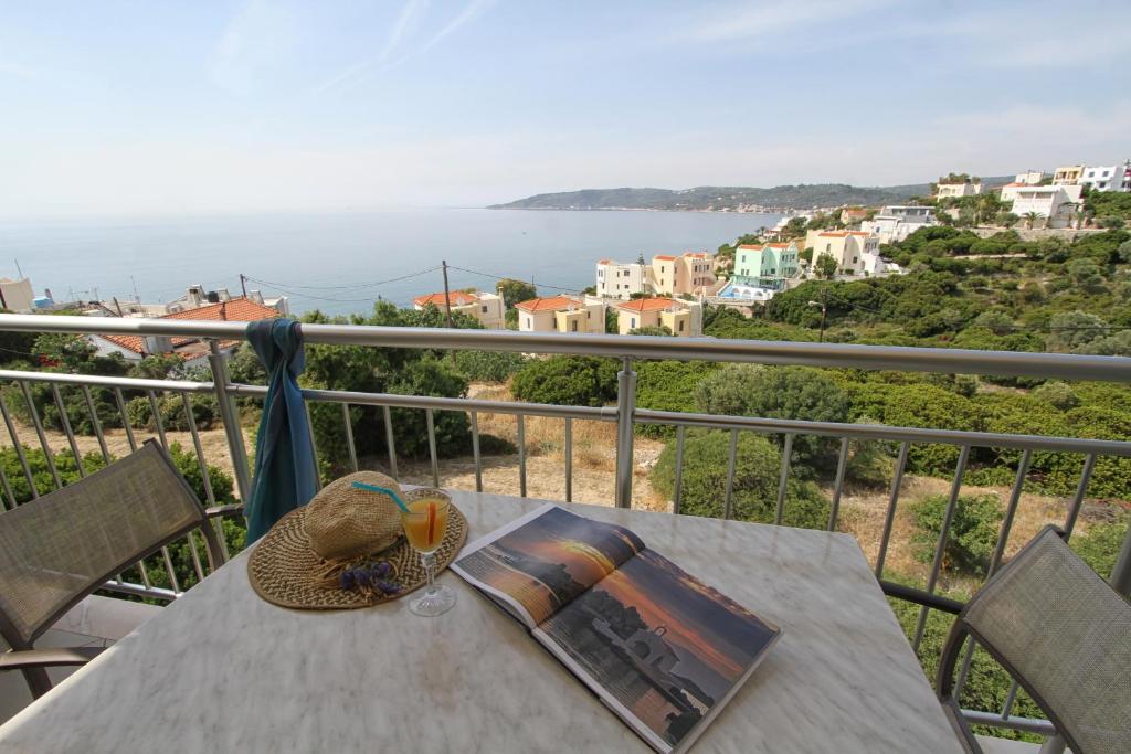 a table with a book on top of a balcony at Skinari Apartments in Monolia