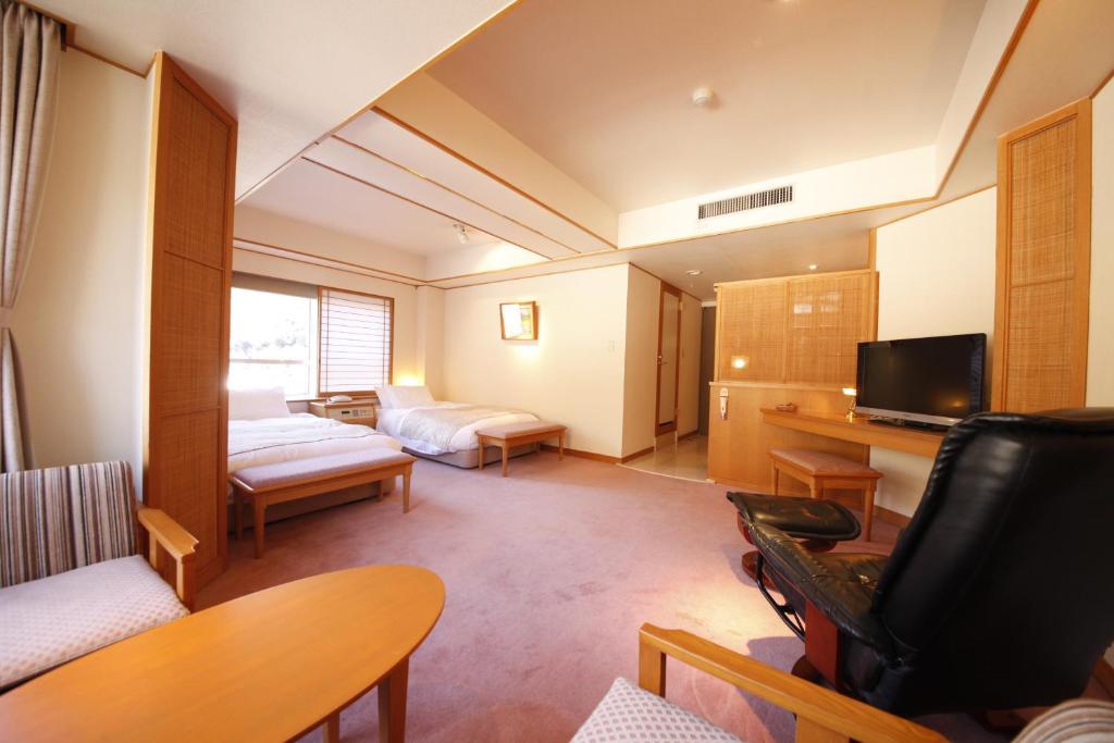 Postel nebo postele na pokoji v ubytování Shimobe Hotel