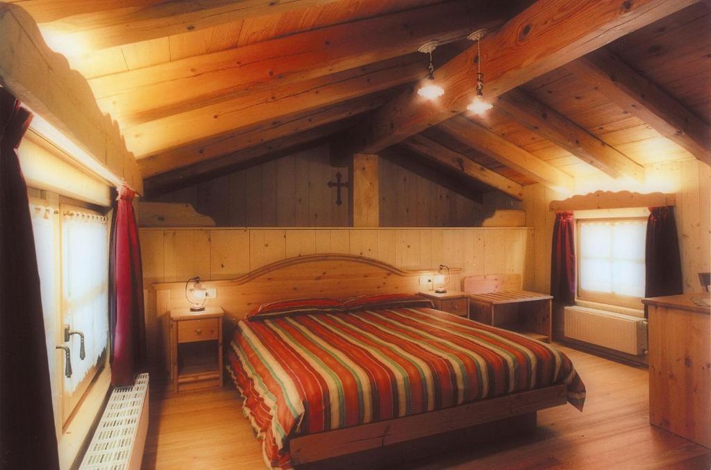 Postel nebo postele na pokoji v ubytování Hotel Garni Plueme