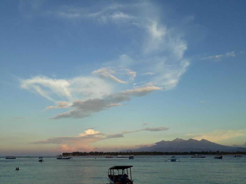 a view of the ocean with boats in the water at Balenta Bungalow Gili Trawangan in Gili Trawangan