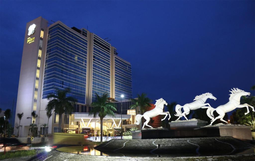 a statue of horses in front of a building at Java Palace Hotel in Cikarang