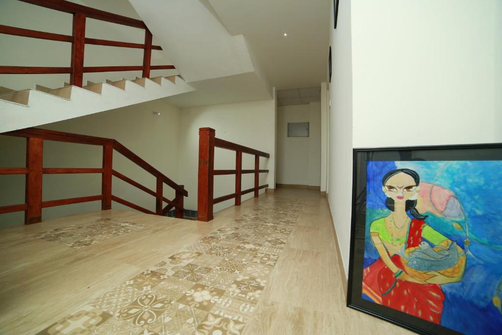 a painting on a wall in a room with two beds at La Lune Fort Kochi in Cochin