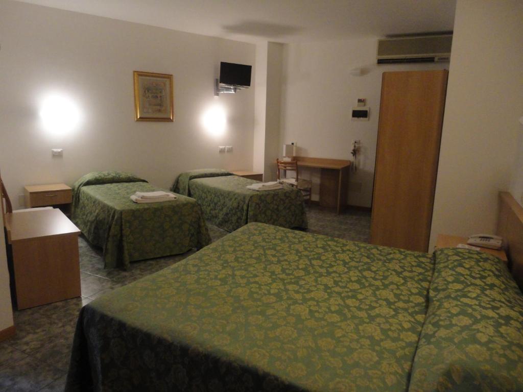 Postel nebo postele na pokoji v ubytování Hotel La Carica