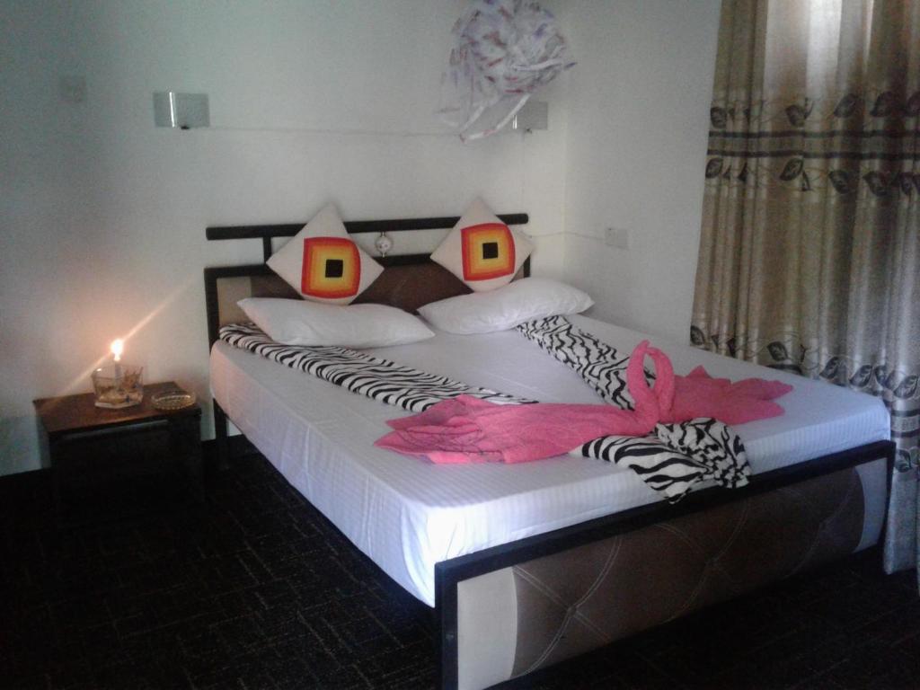 Postel nebo postele na pokoji v ubytování Ella Fresh Point Homestay