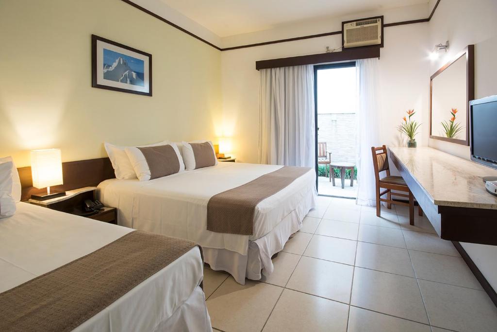 Кровать или кровати в номере Hotel Ilhas da Grécia
