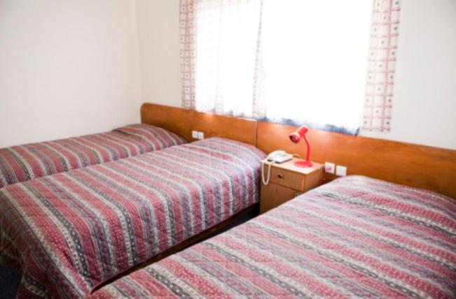 Postel nebo postele na pokoji v ubytování Victoria Hotel