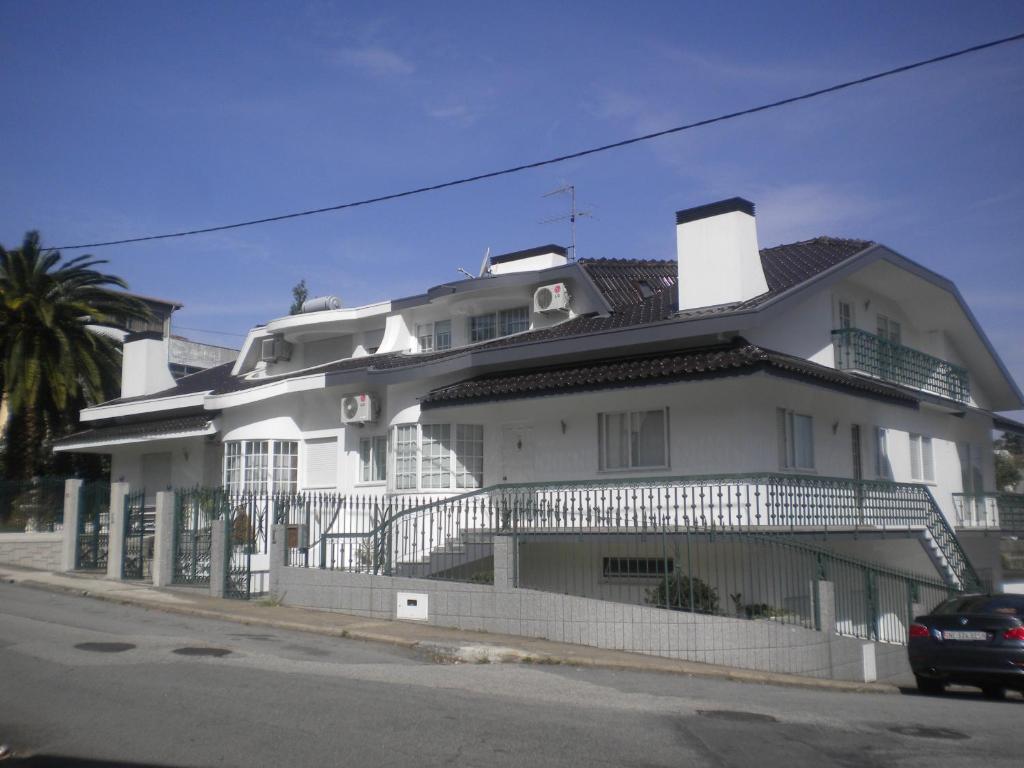 Casa blanca con balcón en una calle en Maison Blanche en Guizande