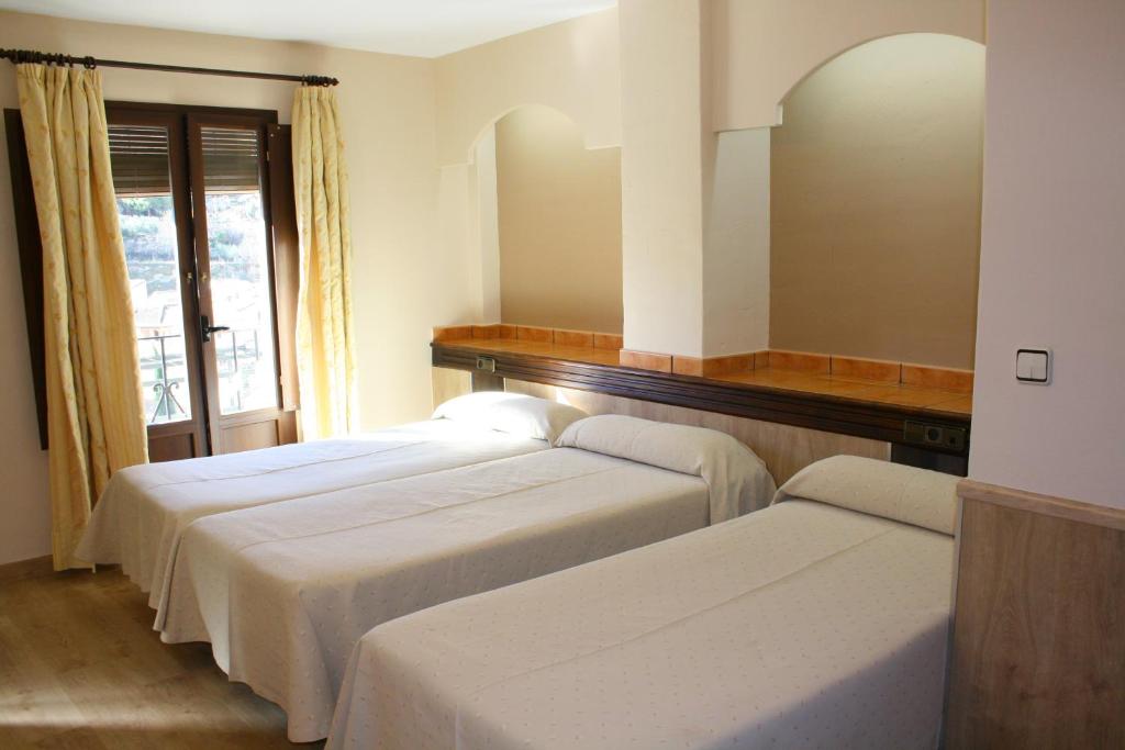 Cama o camas de una habitación en Hotel Rural Huerta del Laurel