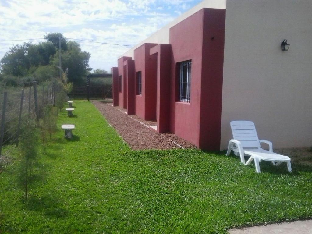 two white chairs sitting on the side of a building at Apartamentos Atlantida in Colón