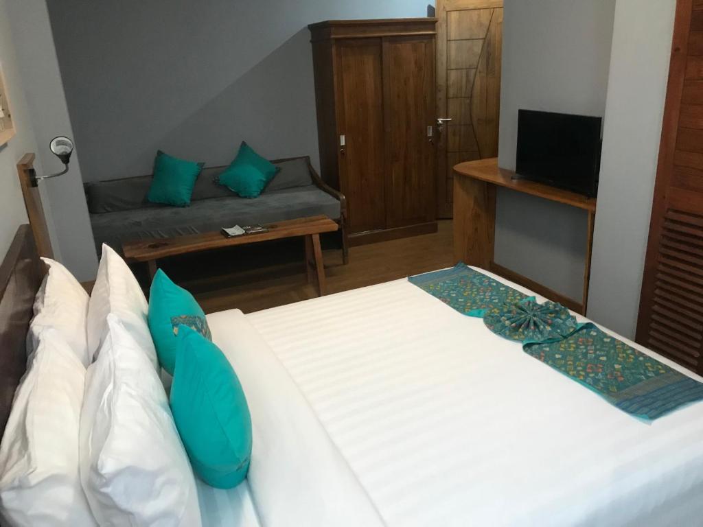 Postel nebo postele na pokoji v ubytování Wae Molas Hotel