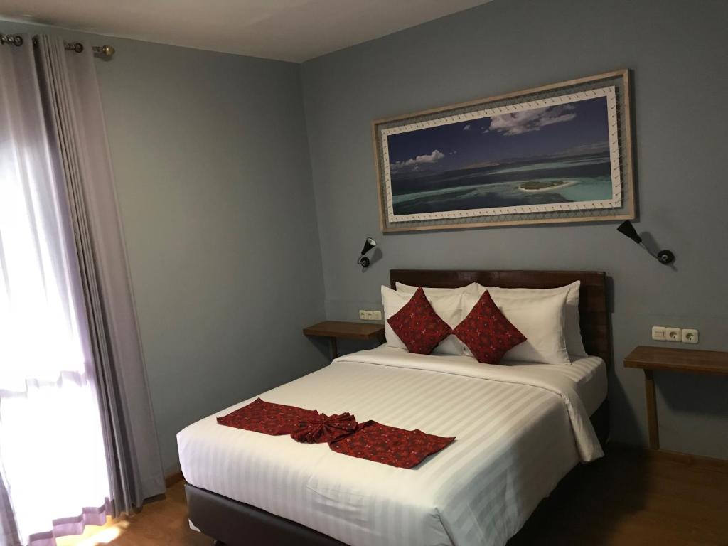 Postel nebo postele na pokoji v ubytování Wae Molas Hotel