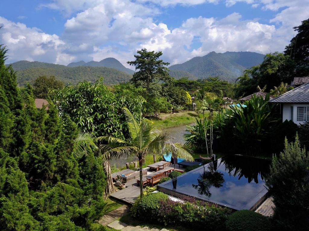 an aerial view of a resort with mountains in the background at RimPai Cottage in Pai