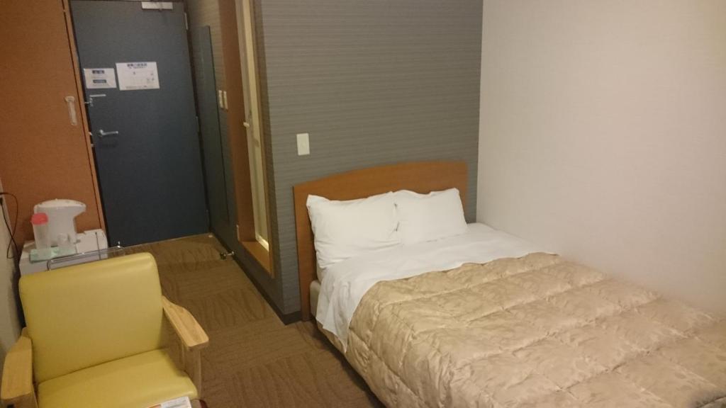 Postel nebo postele na pokoji v ubytování Ikaho Grand Hotel