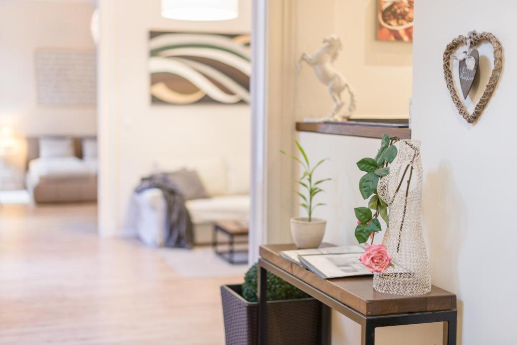 a living room with a table with a plant on it at Paulay Apartment in Budapest