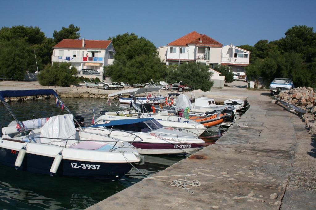 a group of boats are docked in a harbor at Apartments Vili Betina in Betina