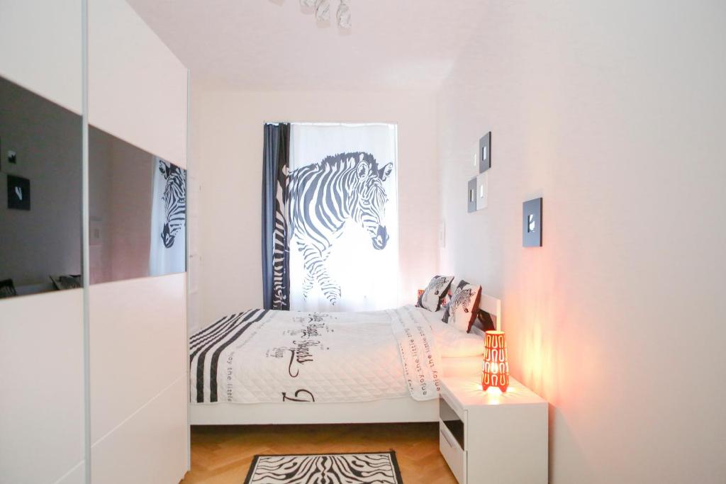 a bedroom with a bed with a picture of a zebra at Stylish apartment a few steps from metro in Prague
