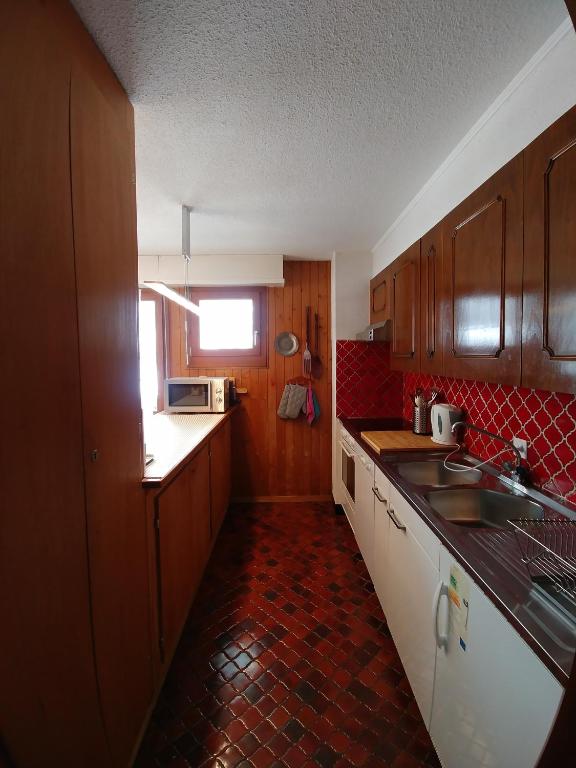Kuchyň nebo kuchyňský kout v ubytování Apartment Champéry Grand Pré A