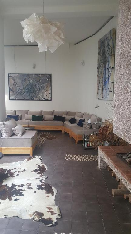a large living room with couches and a rug at Dar d'Art in Marrakesh