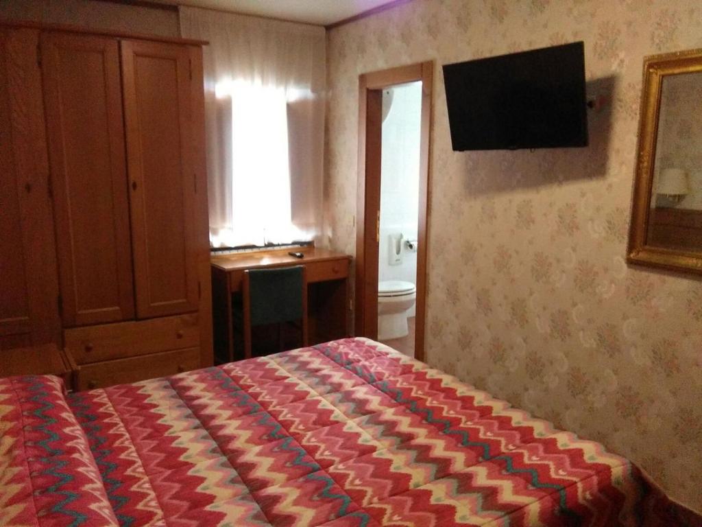 Postel nebo postele na pokoji v ubytování Hotel Sporting