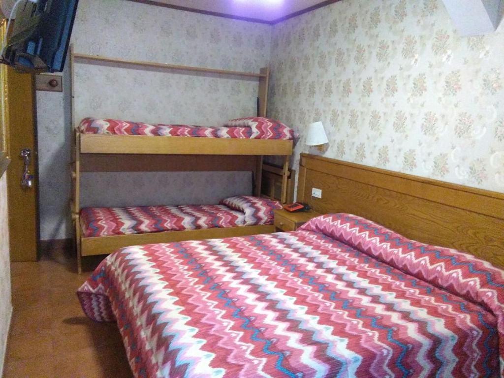 Postel nebo postele na pokoji v ubytování Hotel Sporting