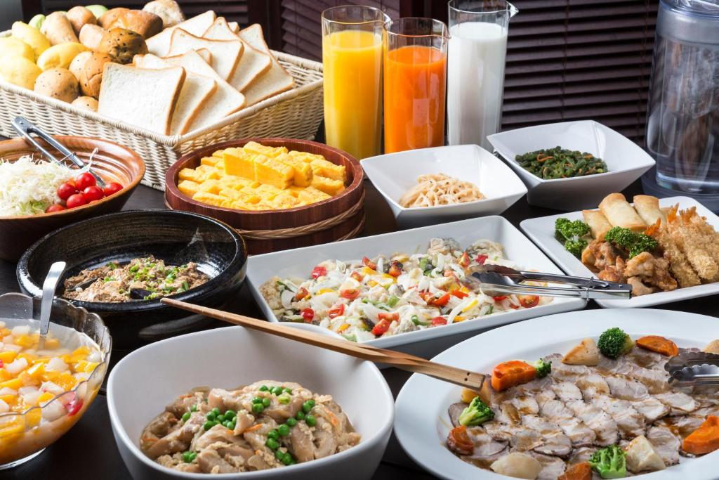 a table topped with bowls of different types of food at HOTEL MYSTAYS Kanazawa Castle in Kanazawa