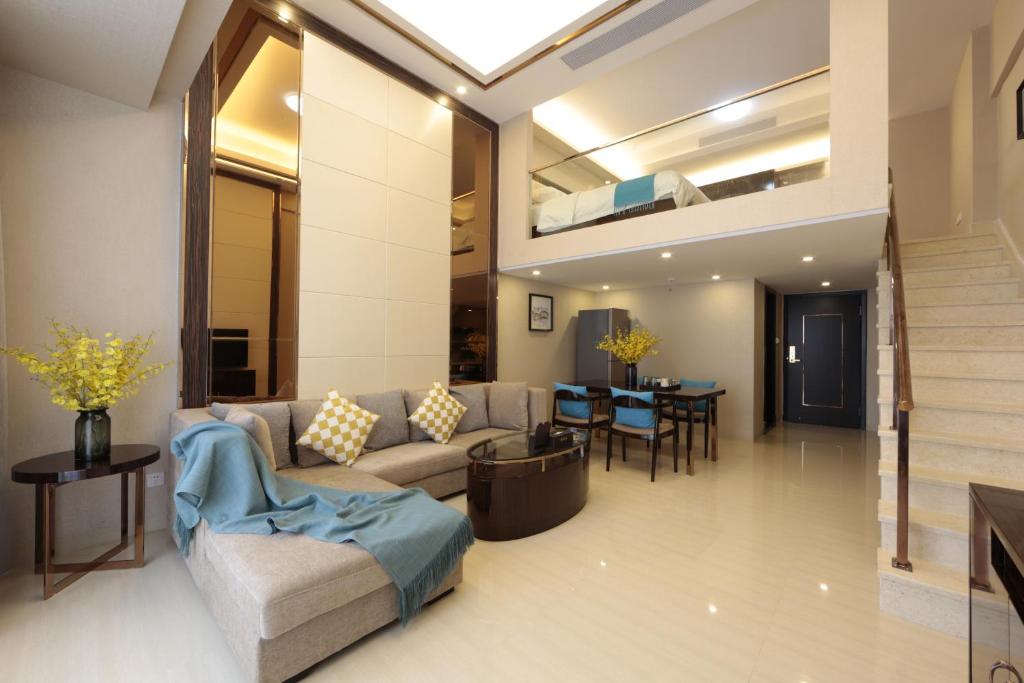 a living room with a couch and a table at WAIFIDEN Duplex Hotel Apartment Zhongyong Jinyu Branch-Free shuttle bus during the Canton Fair in Guangzhou