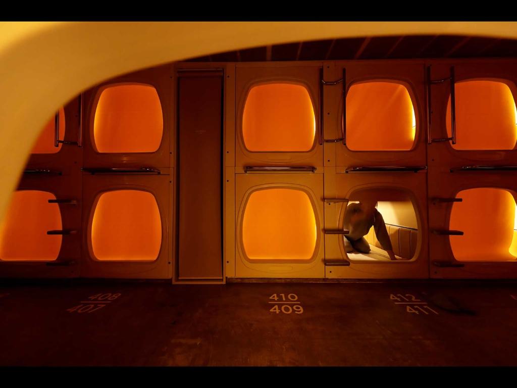 a person is looking out the window of an airplane at Do-c Shibuya Ebisu in Tokyo