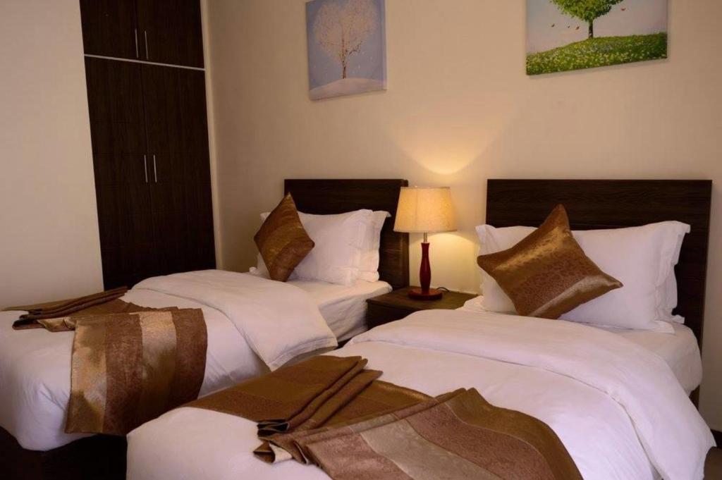 Krevet ili kreveti u jedinici u okviru objekta Olive Hotel Amman