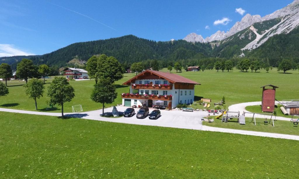 an aerial view of a house with motorcycles parked in front at Pernerhof in Ramsau am Dachstein