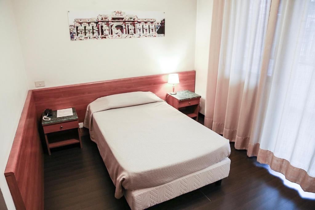 Postel nebo postele na pokoji v ubytování Hotel Sisto V