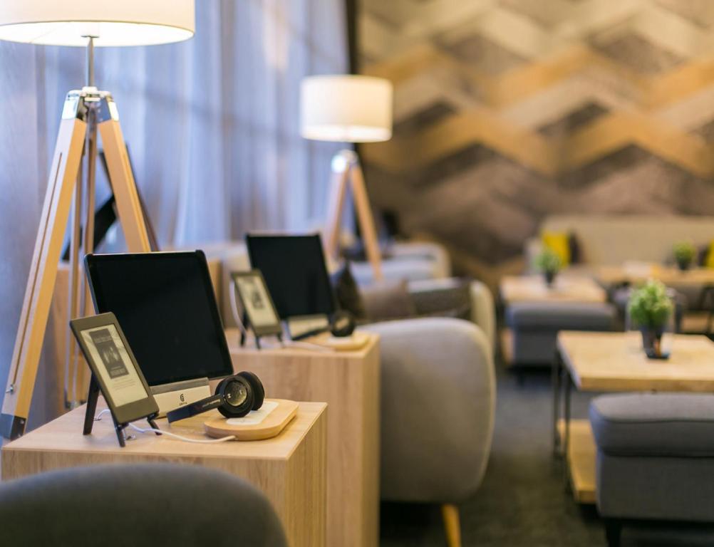 a room with three desks with laptops on them at Valamar Diamant Hotel in Poreč