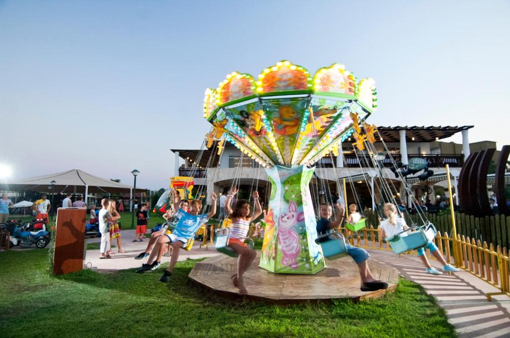 a group of children playing on a carnival ride at Marvida Family Eco - All Inclusive & Kids Concept in Side