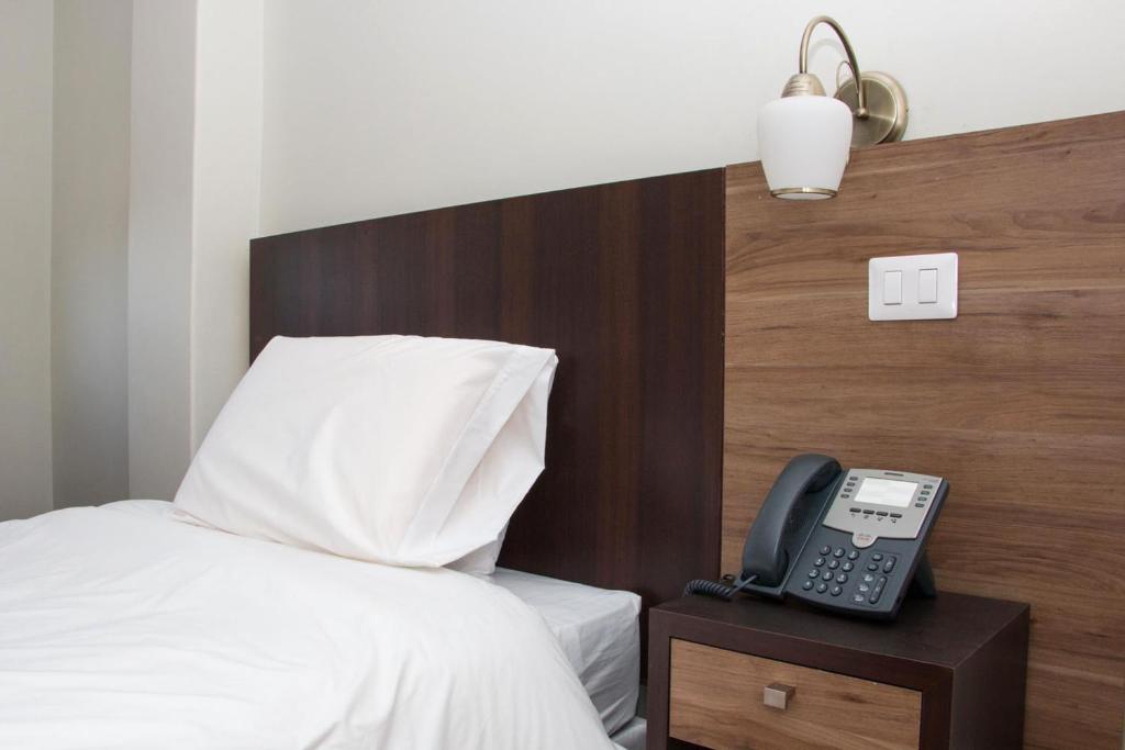 Postel nebo postele na pokoji v ubytování Hotel Plaza Ñuñoa
